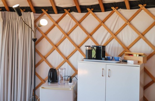 Palm Beach Cabin | Awaawa Yurts - Rangi Yurt - Awaawa Yurts offer a luxury glamping experience on Waiheke Island. Stunning views, luxury queen sized bed, private bathroom with tea and coffee making facilities.